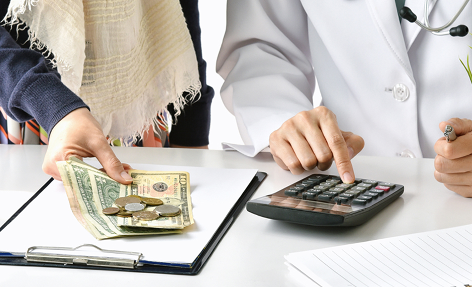5.1-Box-1---stock-photo-hospital-and-medical-expense-doctor-and-woman-patient-calculate-on-disease-treatment-fee-charges